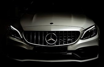 Vehicle front of a Mercedes AMG in light and shadow