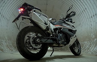 Gloomy shot of a motorbike in a round tunnel