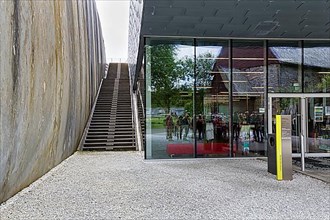 Visitors reflected in glass facade