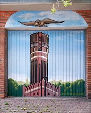 Graffito with Lueneburg water tower on a garage door