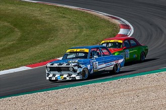 Historic race cars in front BMW 2002ti behind Ford Escort at car race for classic cars Youngtimer Classic Cars 24-hour race 24h race