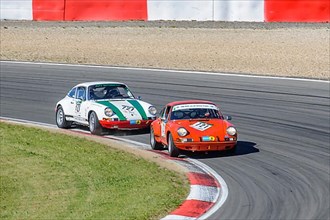 Two historic racing cars Porsche 911 close together in curve at car race for classic cars Youngtimer Classic Cars 24-hour race 24h race