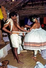 Kathakali actor being fitted with his costume