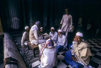 Muslim old men sitting in the Tipu Sultan Mosque and listening Quran in Kolkata Calcutta