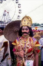 Maveli or king Mahabali model dressing with ornaments and umbrella for onam festival in Kerala