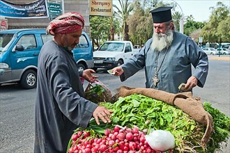 Vegetable vendor and Greek Orthodox priest