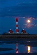 Westerheversand lighthouse at night and full moon in Westerhever