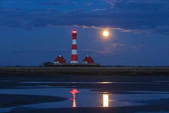 Westerheversand lighthouse at night and full moon in Westerhever