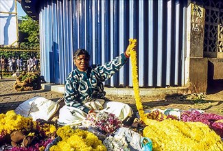 A woman selling flower at City Market in Bengaluru Bangalore