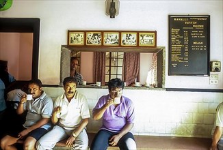 People drinking coffee in the famous Mavalli Tiffin Rooms in Bengaluru Bangalore