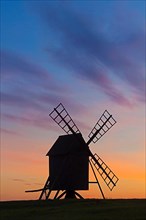 Traditional windmill at Resmo silhouetted against sunset on the island of Oeland
