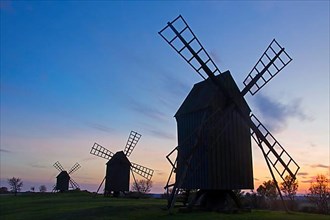 Row of windmills at Resmo silhouetted against sunset on the island of Oeland