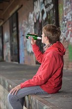Youth drinks beer