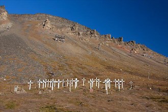 White wooden crosses on graves in the old cemetery of Longyearbyen in summer
