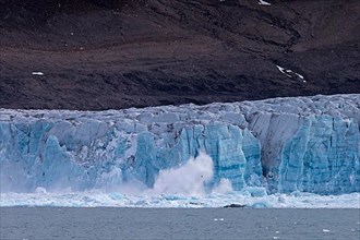 Calving ice of the Samarinbreen glacier flowing into Samarinvagen