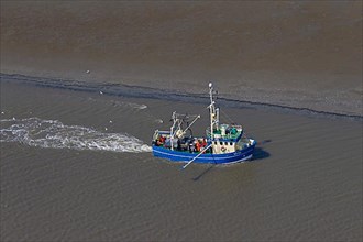 Aerial view of a blue crabber fishing for crabs along the coastline