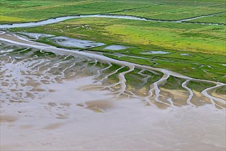 Aerial view over salt marsh and mudflats at low tide
