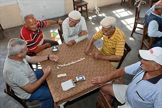 Men playing dominoes in teahouse