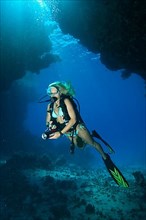 Diver in coral cave