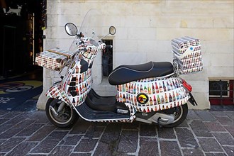 Advertisement for Belgian beers on a scooter