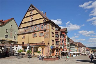 Yellow house with mural and fountain in the main street in Rottweil