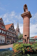 Market square and market fountain with town coat of arms and steeple of the town church of St. Peter and Paul in Calw
