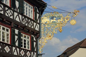 Golden nose sign with stagecoach of Restaurant and Hotel Alte Post in Nagold