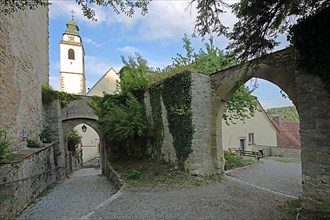 Castle garden with archway as historic town fortification with church tower of the collegiate church in Horb am Neckar