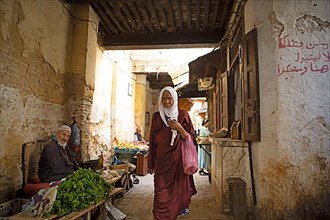 Old Moroccan woman in an old town alley