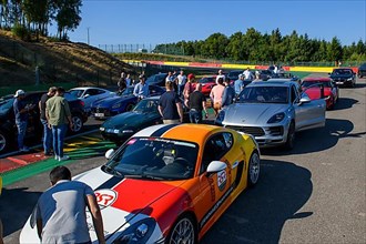 Parked cars of participants of trackday during track inspection of race track for motorsport car racing