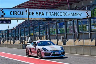 Racing car Sports car Porsche Cayman GT4 drives through pit lane Pit Lane of race track