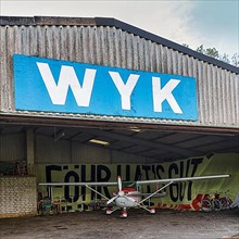 Light aircraft standing in hangar