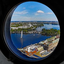City view of the Inner Alster Lake through the porthole windows in the spire of the Hauptkirche St. Petri