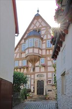 Half-timbered house Buergermeister Elsaesser Haus built 1717 in backlight in Bad Wimpfen