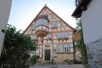 Half-timbered house Buergermeister Elsaesser Haus built 1717 in backlight in Bad Wimpfen