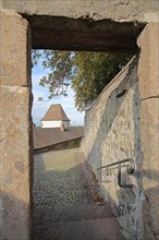 View through gate of the city wall on historic Hagenbach Tower on the castle in Breisach