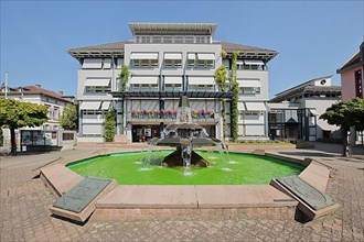 Town hall and fountain with green water at Leopoldsplatz in Eberbach