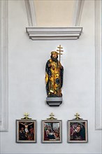Figure of the saint and three stations of the cross