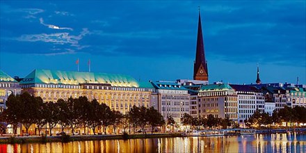 Inner Alster Lake with Ballin House and the main church St. Petri in the evening