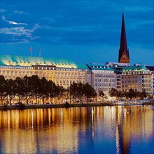 Inner Alster Lake with Ballin House and the main church St. Petri in the evening
