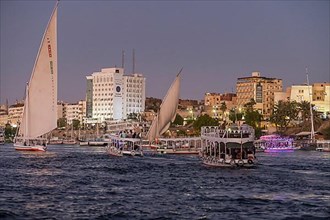 Sailing ships and excursion boats on the evening Nile at Aswan