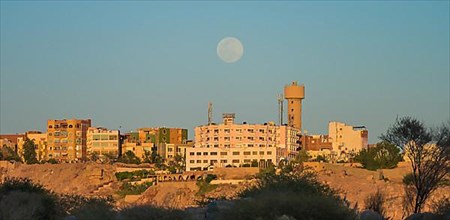 Full moon over housing estate south of Aswan
