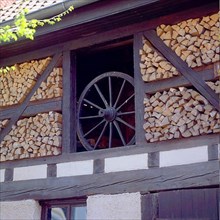 Firewood store with wagon wheel