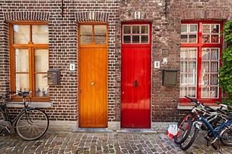 Doors of old houses and bicycles in european city. Bruges