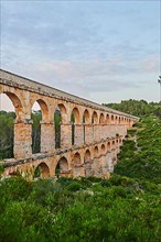 Old roman aqueduct at sunrise