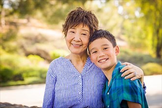 Outdoor portrait of a biracial chinese and caucasian boy and his chinese grandmother