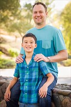 Outdoor portrait of biracial chinese and caucasian father and son