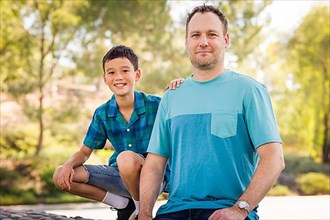 Outdoor portrait of biracial chinese and caucasian father and son