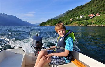 Boy on motorboat