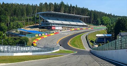 Panoramic photo of view from racing car perspective of racing driver while driving into dangerous curve Eau Rouge on 40 metres high driveway Raidillon of race track Circuit de Spa Francorchamps